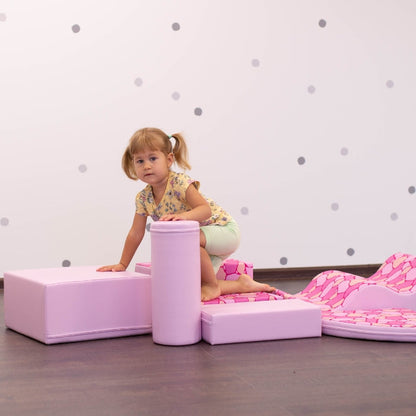 A girl playing with a pink IGLU soft play set