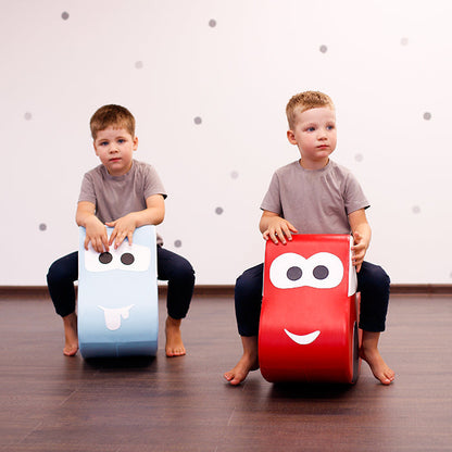 Two boys playing with their toy car rockers