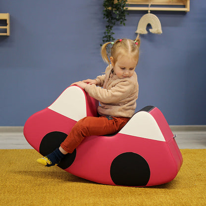 A girl rocking in a car shapes IGLU toy