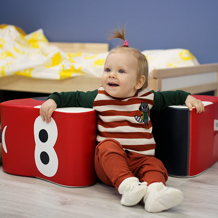 A baby playing with IGLU's car rocker