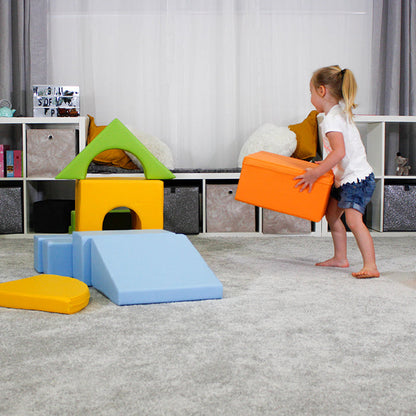 A girl playing with a foam soft play set