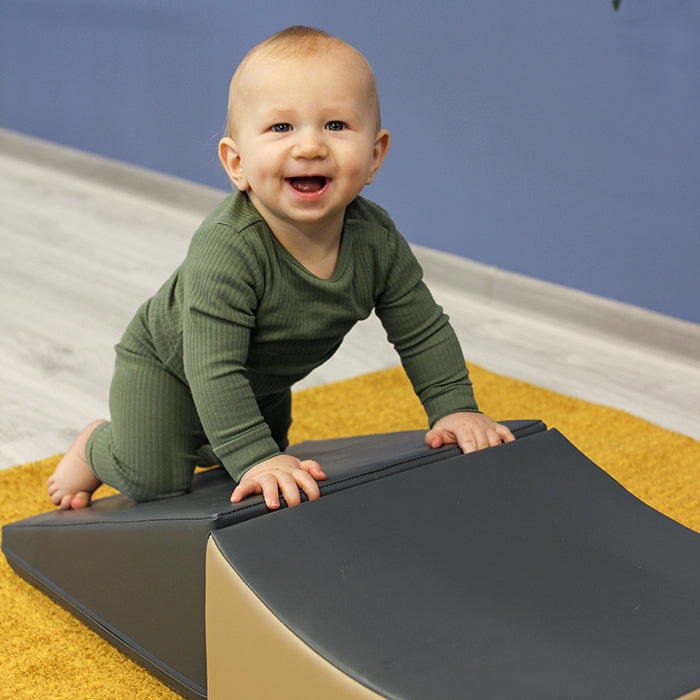 A baby is sitting on top of an IGLU Soft Play - Wave Venture.