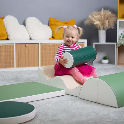 A little girl is playing with a green shape from IGLU set